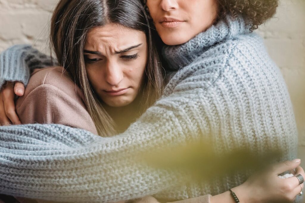žena utěšuje kamarádku po rozchodu
